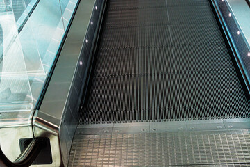 Closeup of metallic escalator surface at the airport. Detailed  shot of the metallic ridges on an...