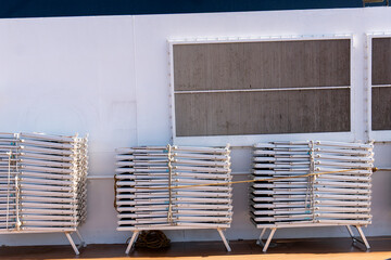 Sun loungers stored on the deck of a cruise ship while cruising