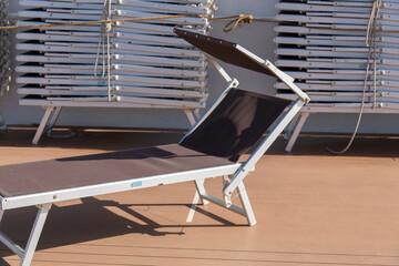 Sun loungers stored on the deck of a cruise ship while cruising