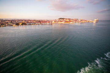 Lisbon Portugal . Sunset view of the Tagus River in Lisbon from the deck of a cruise ship departing from the port in Alfama.