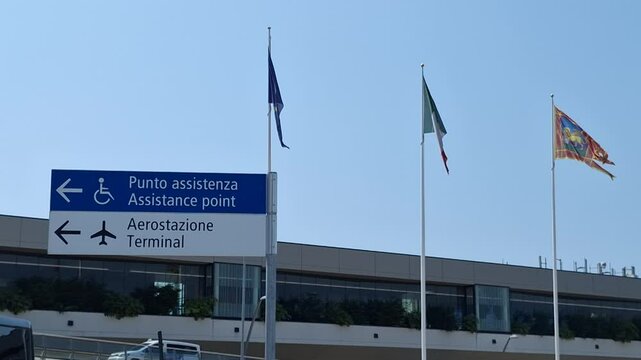 Waving flags and signs at the Marco Polo International Venice Airport