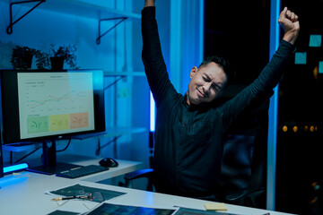 Portrait of a man working overtime at the office. Employee working hard, stressed, tired, working...
