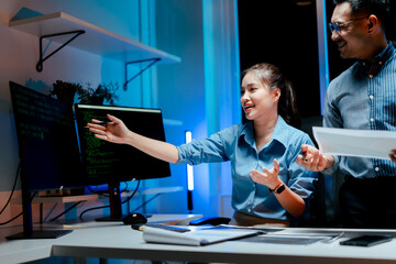 Team of programmers working late at night at a software development company, web developers, and...