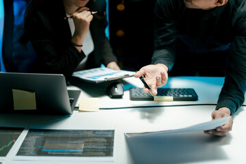 Teamwork colleagues working in the evening to develop or plan discussions, suggestions or ideas...