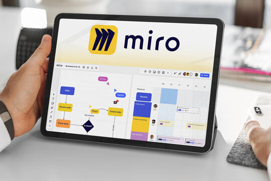 Businessman using miro software on tablet for project management and brainstorming