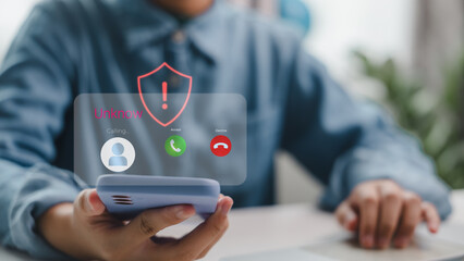 Mobile phone receiving scam call from unknown number with security alert symbol. Illustrates phone fraud, cyber threat, identity theft risk, and awareness of suspicious communication.