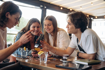 Leisure, having fun. Group of young friends are in the cafe restaurant