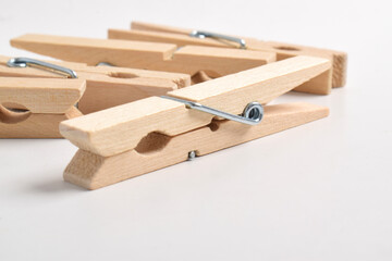 Wooden clothes pegs isolated on white background