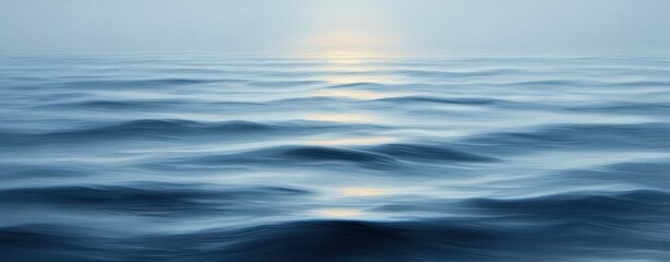Calm ocean waves with gentle ripples under soft light creating a serene and peaceful atmosphere