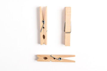 Wooden clothes pin isolated on white background. Top view, flat lay