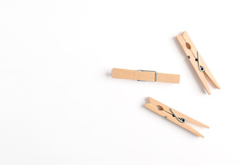 Wooden clothes pin isolated on white background. Top view, flat lay