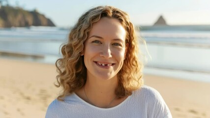 Smiling woman enjoying a sunny day at the beach with ocean waves in the background - Powered by Adobe