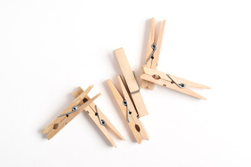 Wooden clothes pin isolated on white background. Top view, flat lay