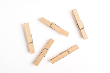 Wooden clothes pin isolated on white background. Top view, flat lay