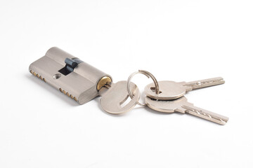 The cylinder of the lock with a pair of keys and isolated on the white background.