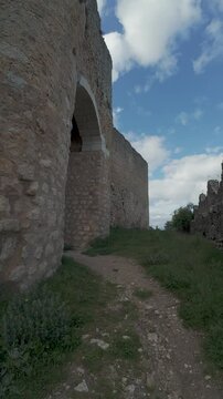 Walking through ancient castle ruins on sunny day