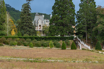 Massandra Palace of Emperor Alexander III. A grand, historic mansion nestled amidst lush greenery...
