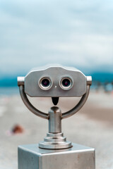 Seaside Binocular Viewer with Blurred Beach Background