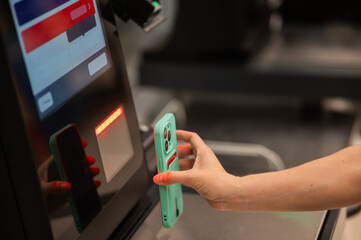 Woman scanning discount on phone at self-checkout. 