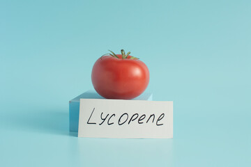 Bright red fresh tomato in close-up on a light background with the inscription 