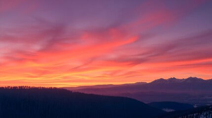 Fototapeta premium Winter sunrise over distant mountain ridge