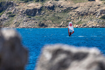 Windsurfing and paragliding in the bay by the beach in Baska on the island of KRK,