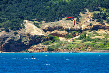 Windsurfing and paragliding in the bay by the beach in Baska on the island of KRK,