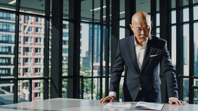 Bald in the middle head and begin no loss hair glabrous of mature Asian business smart active office man.