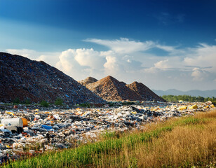 Large Landfill Site with Waste Underneath a Clear Evening Sky