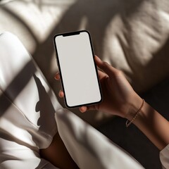 Woman holding smartphone with blank screen in natural light setting