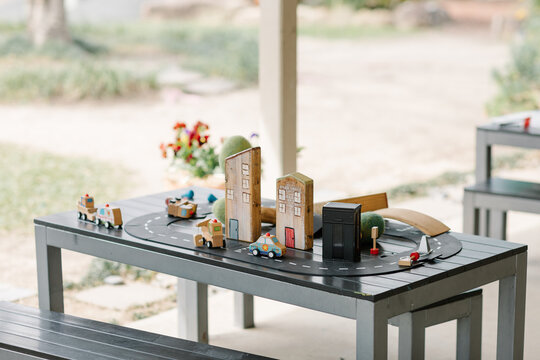 Wooden car toy and buildings a street concept setup on a table at childcare centre