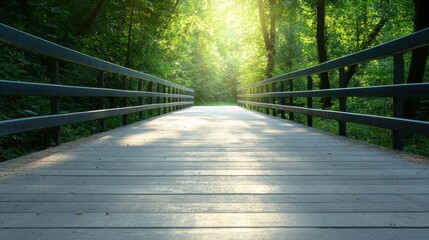 Obraz premium A serene wooden bridge stretches through a vibrant green forest, illuminated by soft sunlight filtering through the leaves, creating a tranquil ambiance perfect for reflection.