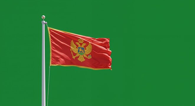 Montenegro's vibrant flag billows proudly against a crisp green backdrop.