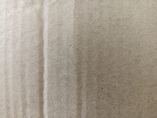 Brown Cardboard Surface Close-Up with Natural Fold Lines. Photo of a plain brown cardboard surface...