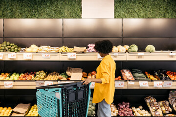 Customer choosing fresh produce in sustainable grocery store