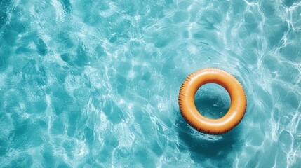 A vibrant orange lifebuoy floats atop sparkling turquoise water, representing safety and fun in summer adventures and the joy of aquatic leisure activities.