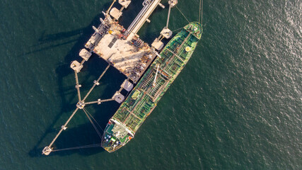 Aerial view oil ship tanker vessel loading and unloading in oil terminal station refinery, Global...