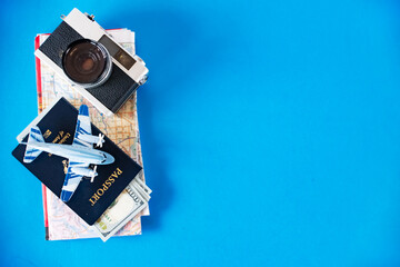 Stylish flat lay with travel gear on blue backdrop. Perfect for promotions.