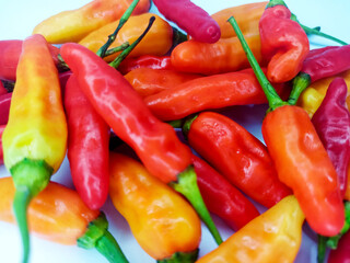 Assorted Colorful Chili Peppers, Red, Yellow, and Orange Hot Peppers Grouped Together on White Background for Spicy Cooking, Natural Food, and Culinary Ingredient Concept for background