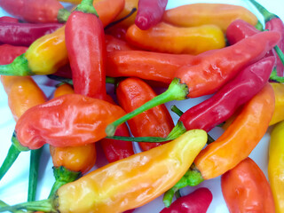 Assorted Colorful Chili Peppers, Red, Yellow, and Orange Hot Peppers Grouped Together on White Background for Spicy Cooking, Natural Food, and Culinary Ingredient Concept for background