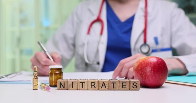A medical professional studies nitrates with an apple, symbolizing health and the importance of medication