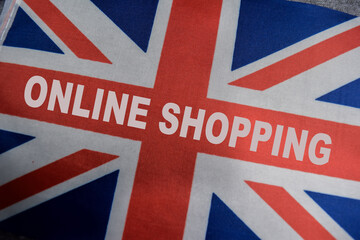 Fototapeta premium British flag sign with word online shopping. promoting english shop