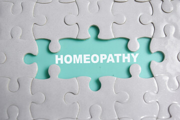 Fototapeta premium Piece of jigsaw puzzle and word homeopathy.