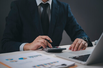Financial professional using calculator and pen, budget management accounting, business data...