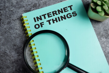 Concept of Internet of things write on book isolated on Wooden Table.