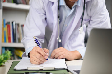 Physician preparing medical forms and reviewing patient history, emphasizing thoroughness in diagnosis, follow-up care, and professional administrative duties.