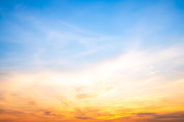 Obraz premium Beautiful , luxury soft gradient orange gold clouds and sunlight on the blue sky perfect for the background, take in evening,Twilight, Large size, high definition landscape photo