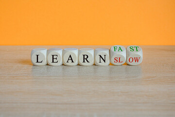 Learn slow or fast symbol. Turned wooden cubes and changes words Learn slow to Learn fast....