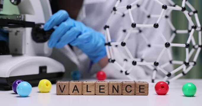 Delving into the concept of valence in chemistry through the use of a microscope and molecular model representations