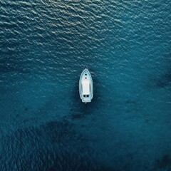 Captivating view of a pristine blue sea with a luxurious white boat peaceful scenic horizon aerial shot